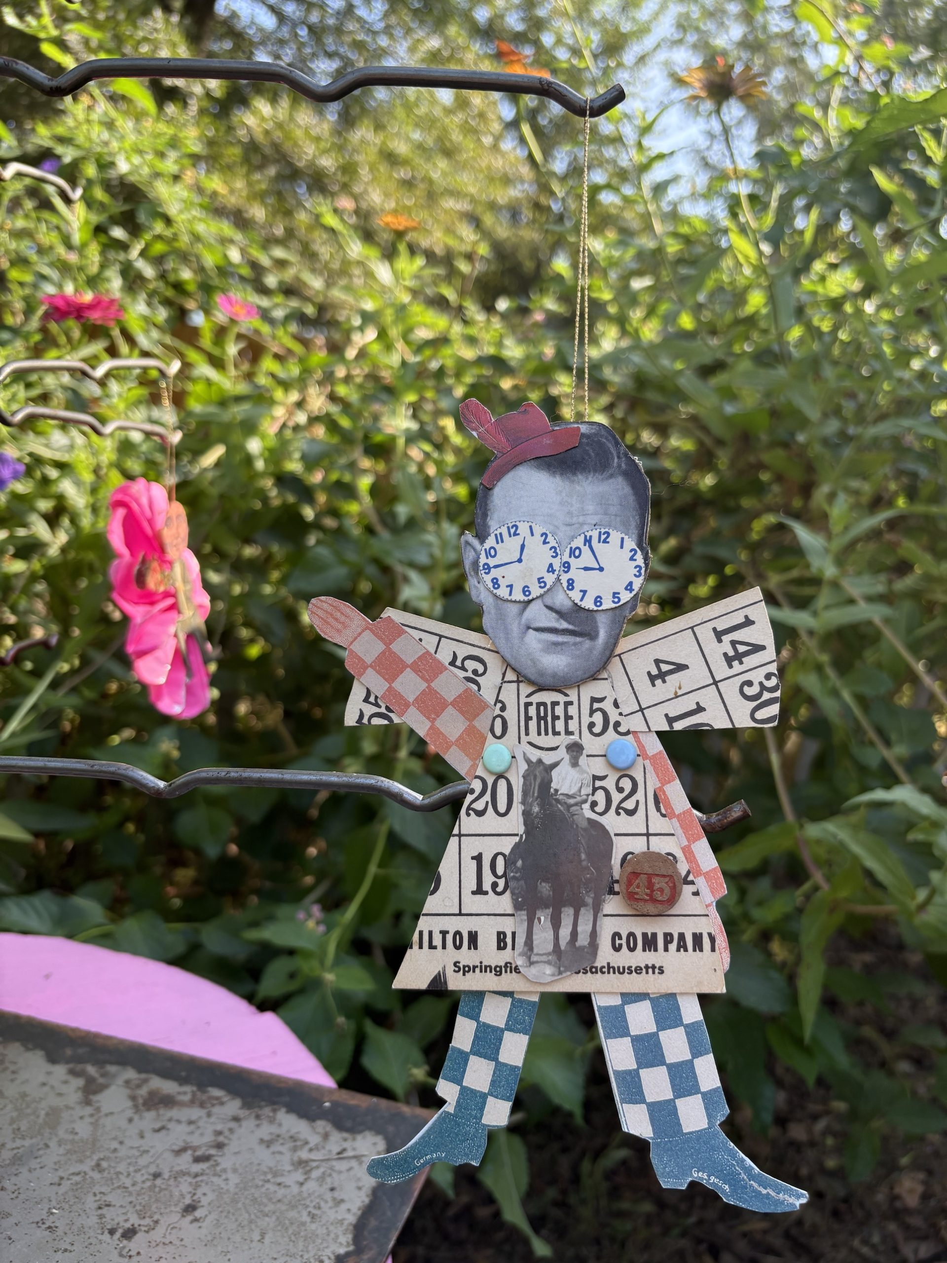 The Duke Plays Bingo ornament hanging in the garden